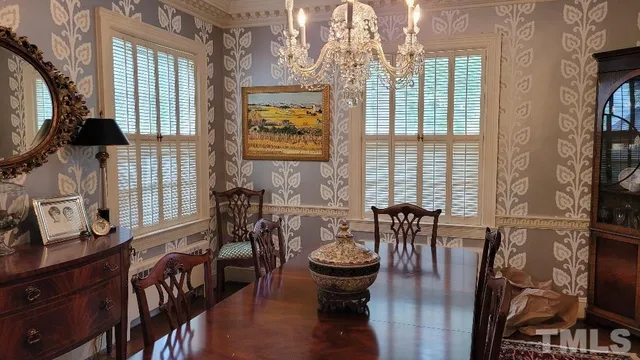 a view of a dining room with furniture and chandelier