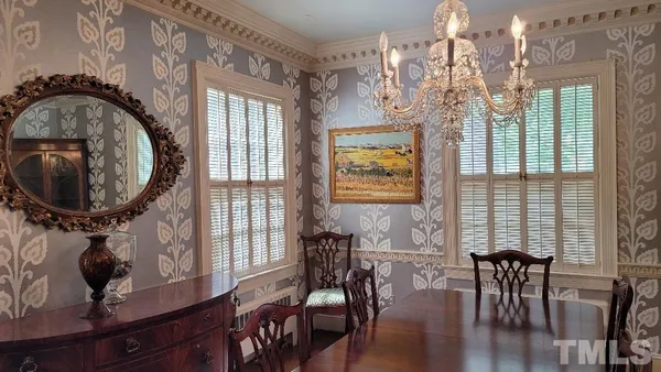 a living room with furniture a fireplace and a window