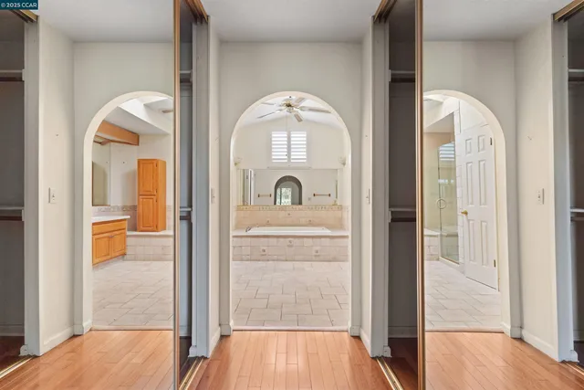 a spacious bathroom with a tub sink and mirror