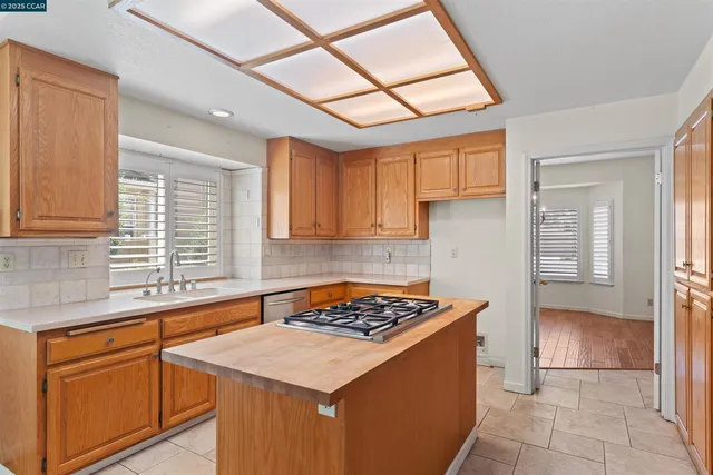a kitchen with a sink cabinets and window