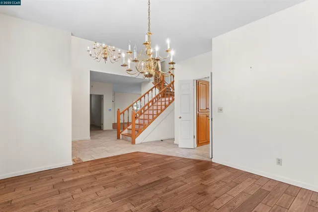 a view of a hallway with entryway and wooden floor