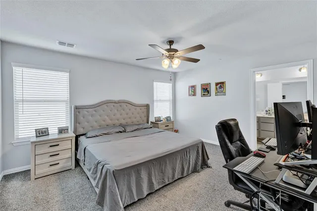 a bedroom with a bed and a chair