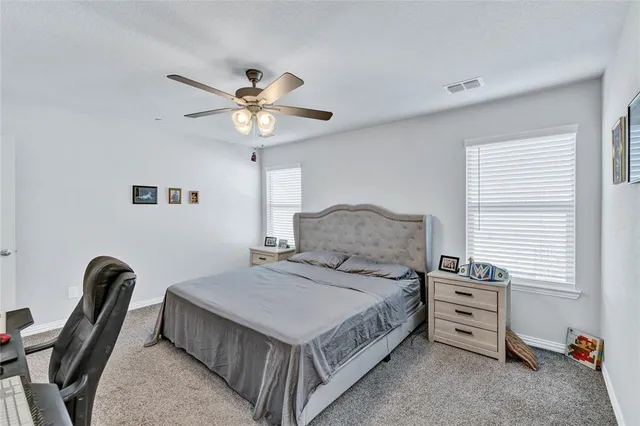 a bedroom with a bed a chandelier and a window