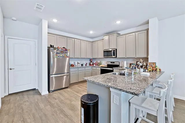 a kitchen with refrigerator and stove