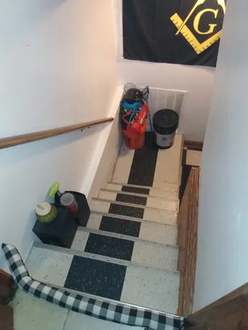 a storage & utility room with a black white checkered floor