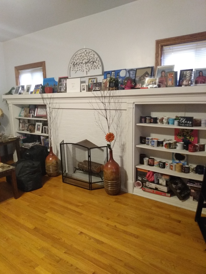 8015 South May Street Chicago, IL 60620 - Photo 4 of 23 a bedroom with furniture and a kitchen