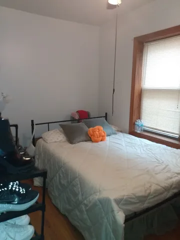 a bedroom with a bed and a dresser