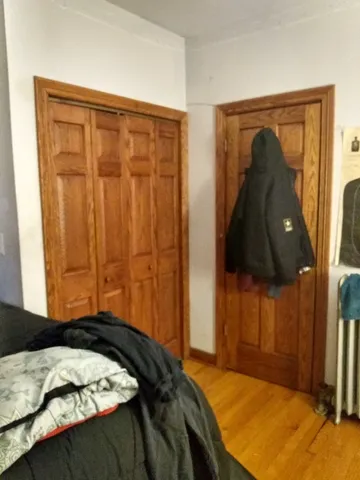a bedroom with a bed and a closet