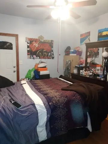 a bedroom with a bed and dresser