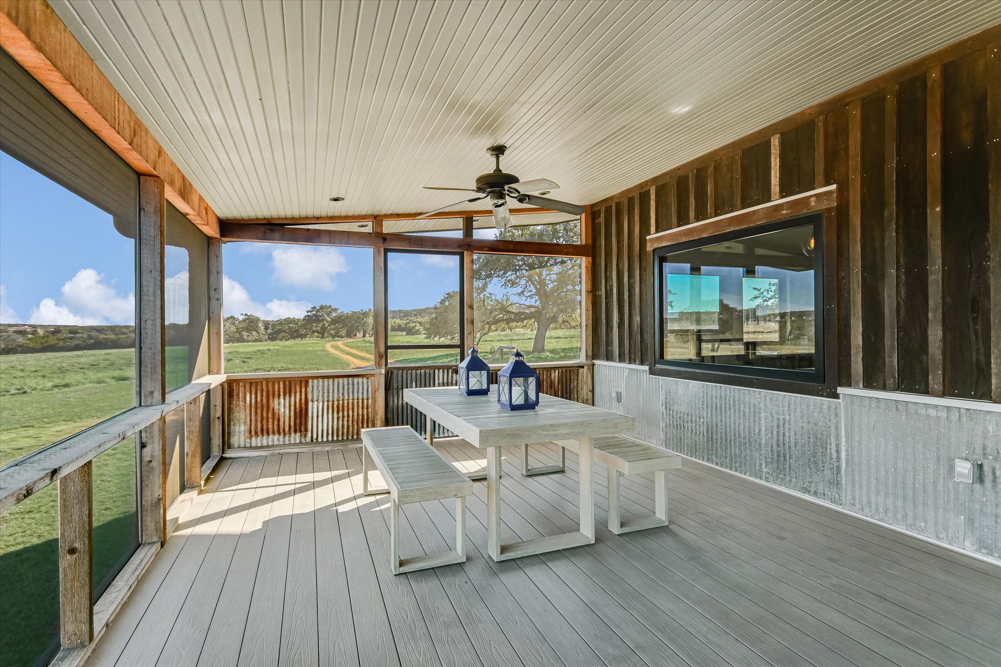 4698 Fischer Store Road Wimberley, TX 78676 - Photo 14 of 28 Relax on this screened porch featuring beadboard ceilings and sweeping views of the pasture.