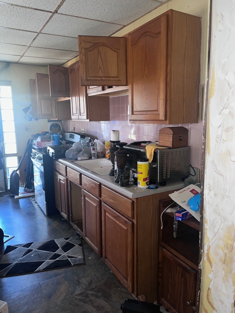 15433 Crocket Lane Markham, IL 60428 - Photo 2 of 10 a kitchen with stainless steel appliances wooden cabinets and a stove top oven