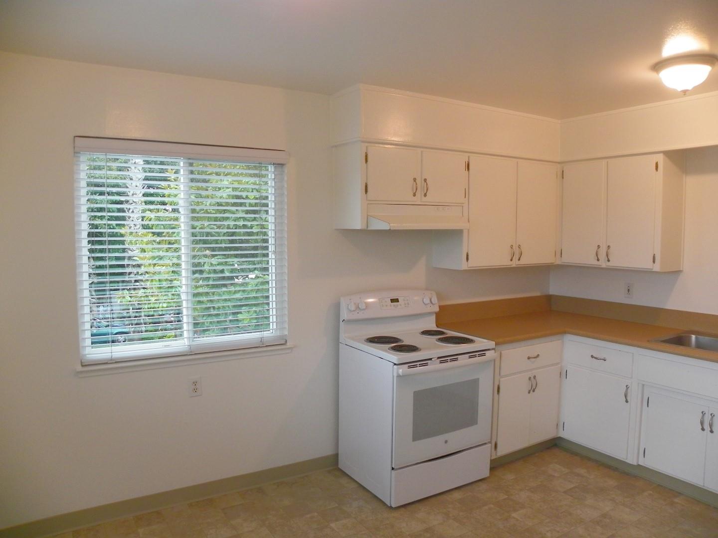 5098 Wilder Drive Soquel, CA 95073 - Photo 10 of 17 a kitchen with granite countertop white cabinets and white appliances