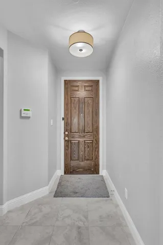 a kitchen with stainless steel appliances granite countertop a sink a stove and a wooden floor