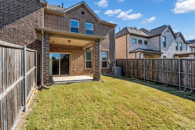 a view of a house with wooden fence