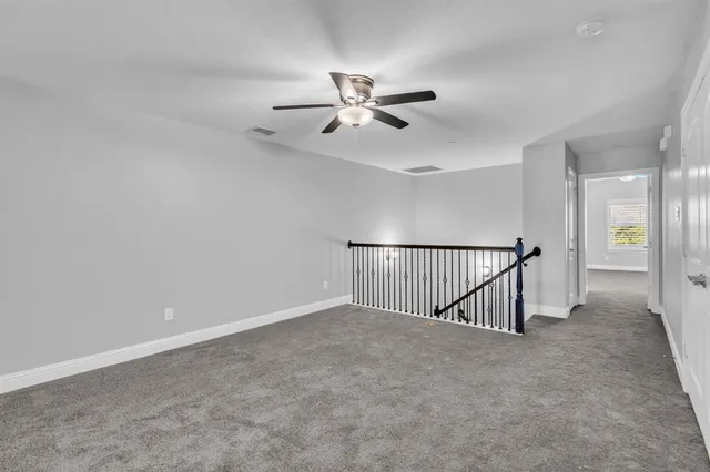 an empty room with closet and windows