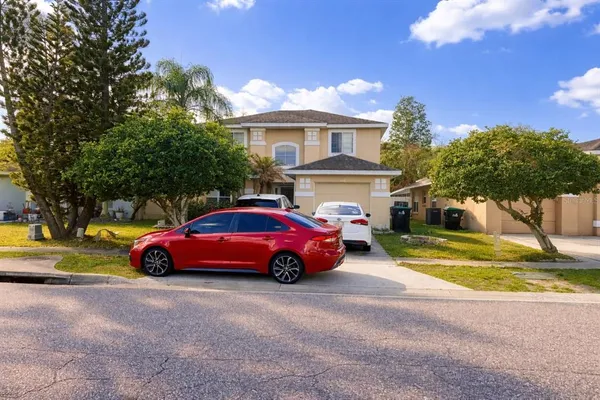 a car parked in front of a house with a yard