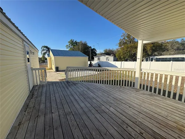 a view of a wooden deck with a yard
