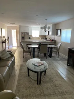 a living room with furniture a dining table and chairs