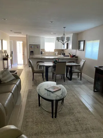 a living room with furniture a dining table and chairs