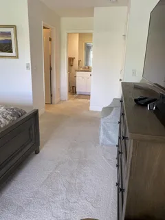 a spacious bathroom with a granite countertop sink a toilet and a mirror
