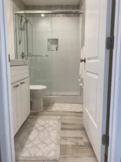 a view of a patio with table and chairs and couches with wooden floor