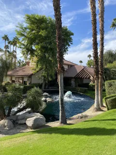 a view of a lake with a yard and outdoor seating