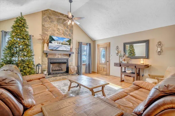 a living room with furniture a chandelier and a floor to ceiling window