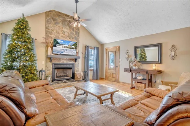 a living room with furniture a chandelier and a floor to ceiling window