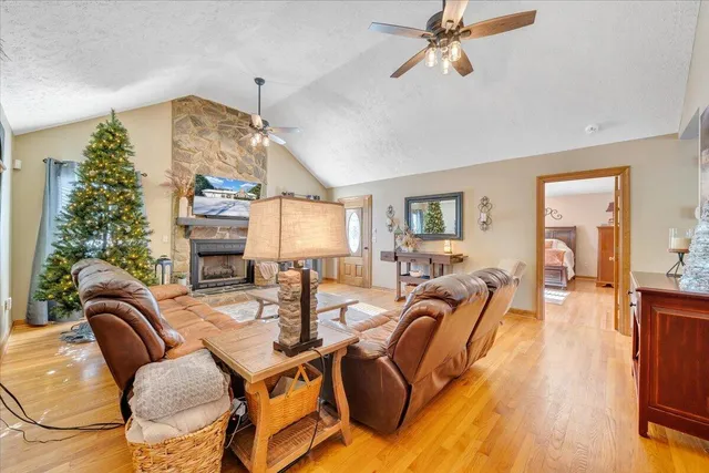 a living room with furniture a flat screen tv and a floor to ceiling window