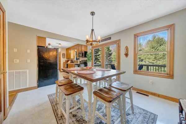 a large kitchen with stainless steel appliances granite countertop a refrigerator and a stove