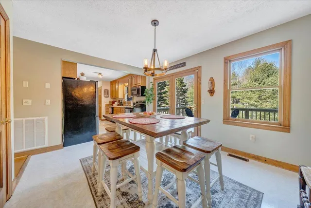 a large kitchen with stainless steel appliances granite countertop a refrigerator and a stove