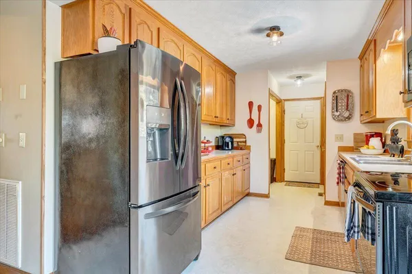 a kitchen with stainless steel appliances a stove a sink and a microwave