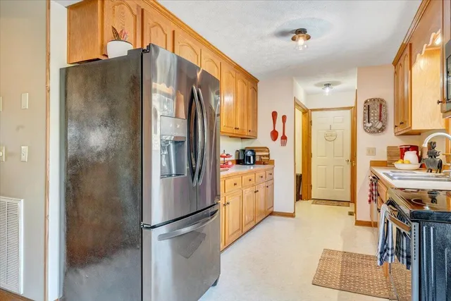 a kitchen with stainless steel appliances a stove a sink and a microwave