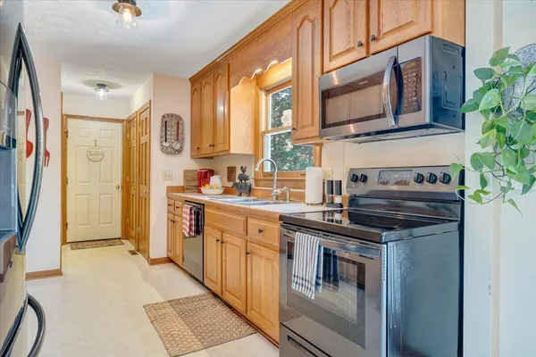 a kitchen with stainless steel appliances granite countertop a sink and cabinets