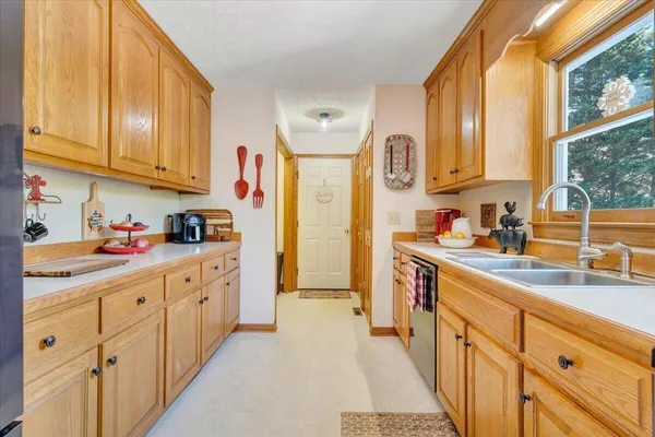a kitchen with stainless steel appliances granite countertop a refrigerator and cabinets