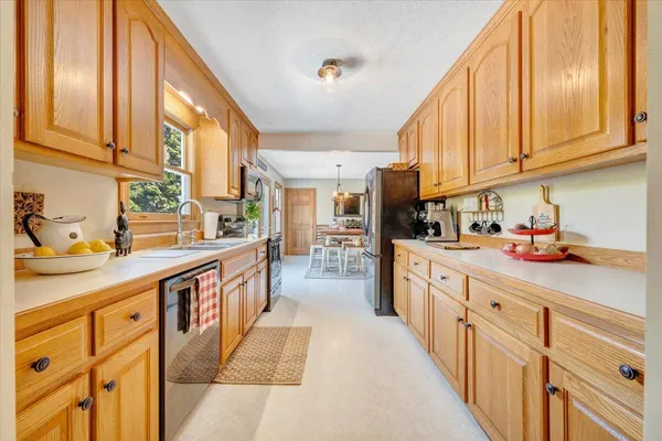a bedroom with a large bed and a chandelier