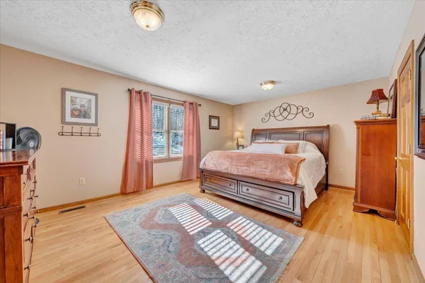 a bathroom with a granite countertop sink a toilet and a mirror