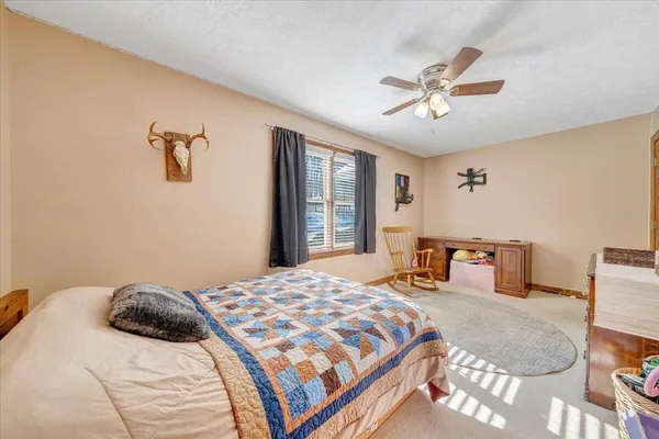 a living room with furniture and a ceiling fan