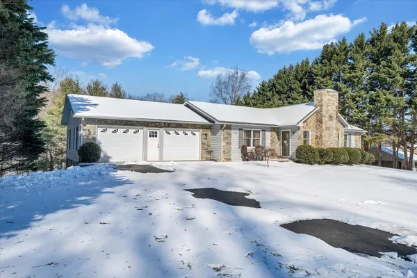 a view of a patio with couple of chairs and a tables
