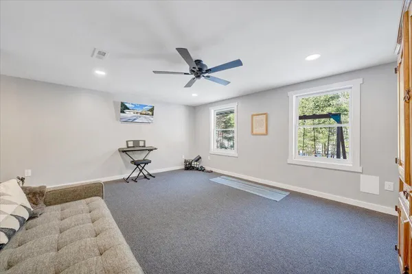 a view of a house with a yard and sitting area