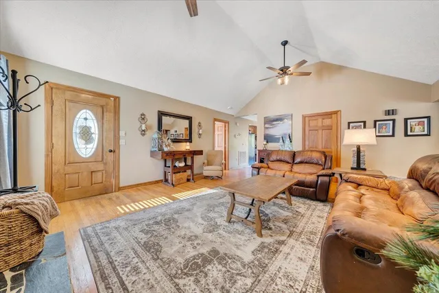 a living room with fireplace furniture and a chandelier