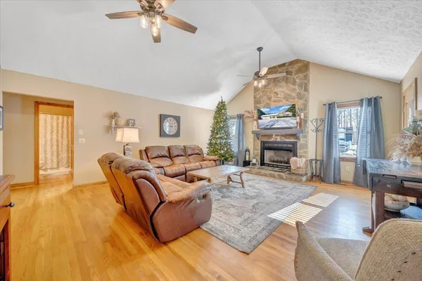 a living room with furniture a fireplace and a chandelier
