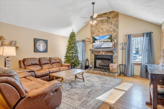 a living room with furniture a fireplace and a chandelier