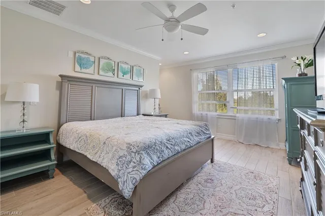 a bedroom with a bed and a flat tv screen on dresser