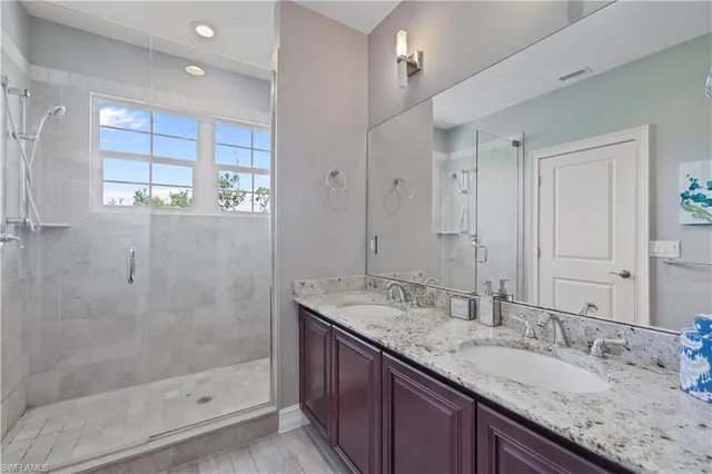 a bathroom with a granite countertop sink mirror and double