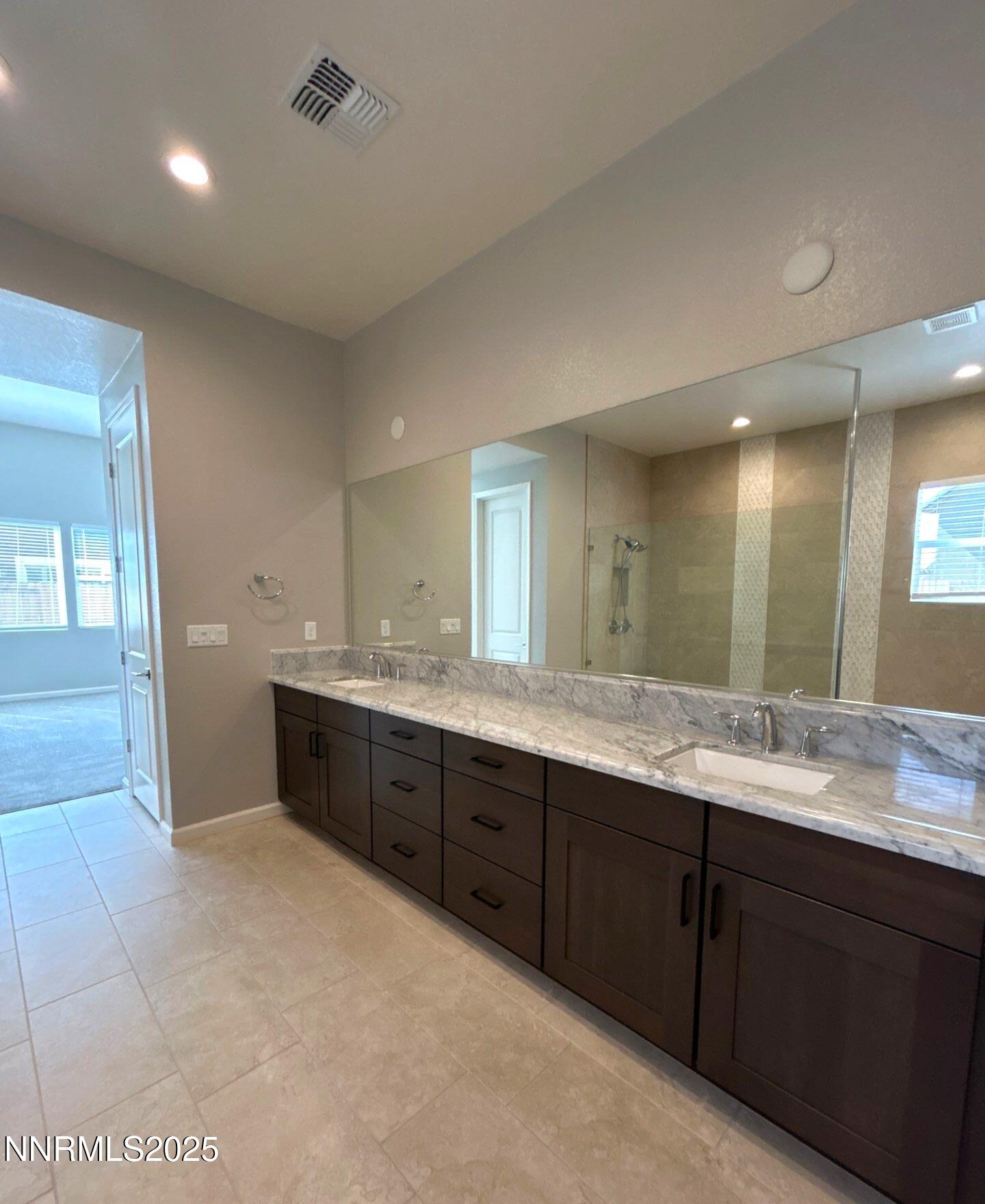 9515 Baldacci Court Reno, NV 89521 - Photo 15 of 27 a bathroom with a granite countertop double vanity sink and mirror
