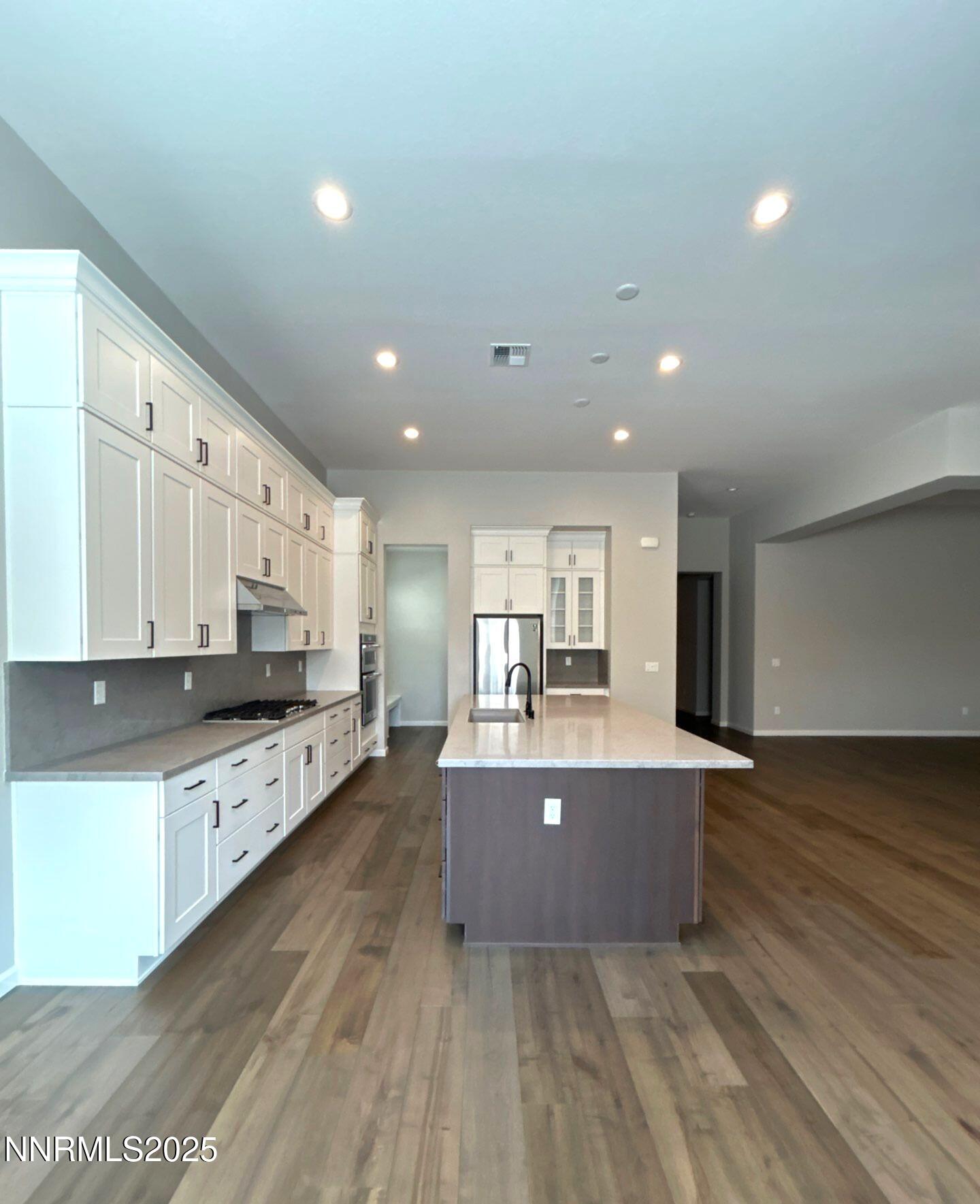 9515 Baldacci Court Reno, NV 89521 - Photo 3 of 27 a living room with stainless steel appliances kitchen island granite countertop a stove and a refrigerator