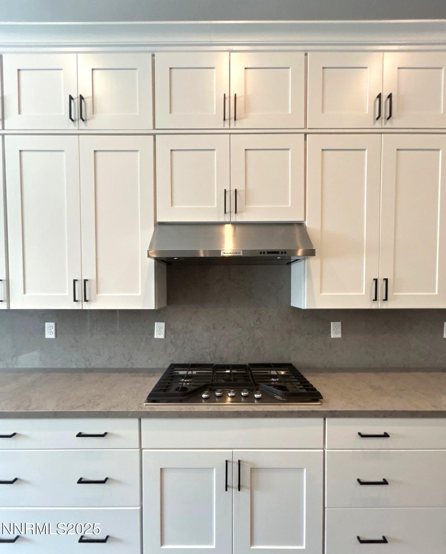 9515 Baldacci Court Reno, NV 89521 - Photo 4 of 27 a kitchen with granite countertop white cabinets and a stove