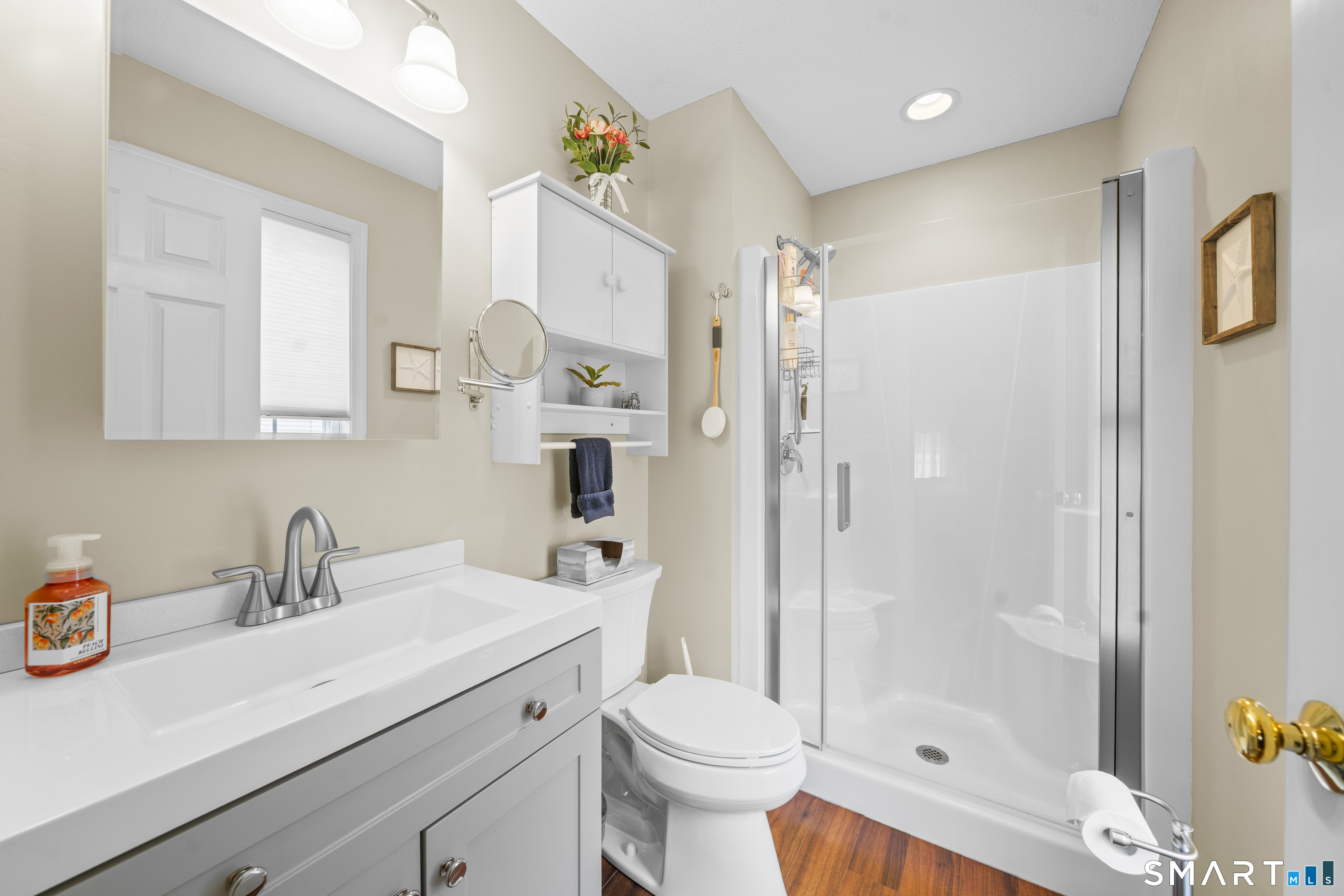 7 Heather Lane, Unit 7 Suffield, CT 06078 - Photo 20 of 34 a bathroom with a sink a toilet and shower