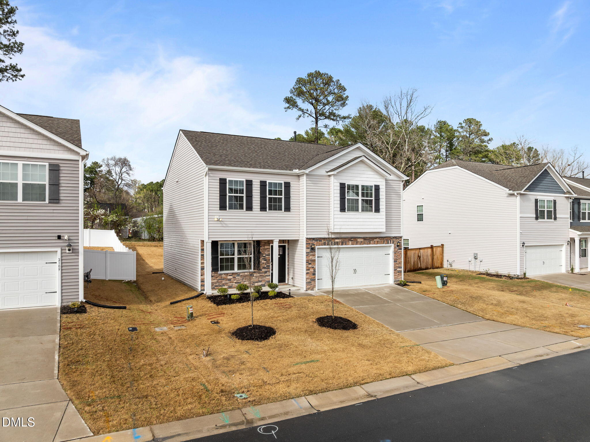 2113 Fletchers Ridge Drive Durham, NC 27703 - Photo 52 of 54 a view of a white house with a yard and large tree